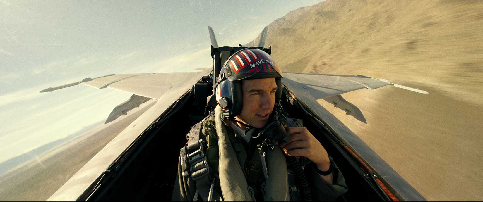 Tom Cruise removes his face mask in the cockpit of a fighter jet in Top Gun: Maverick